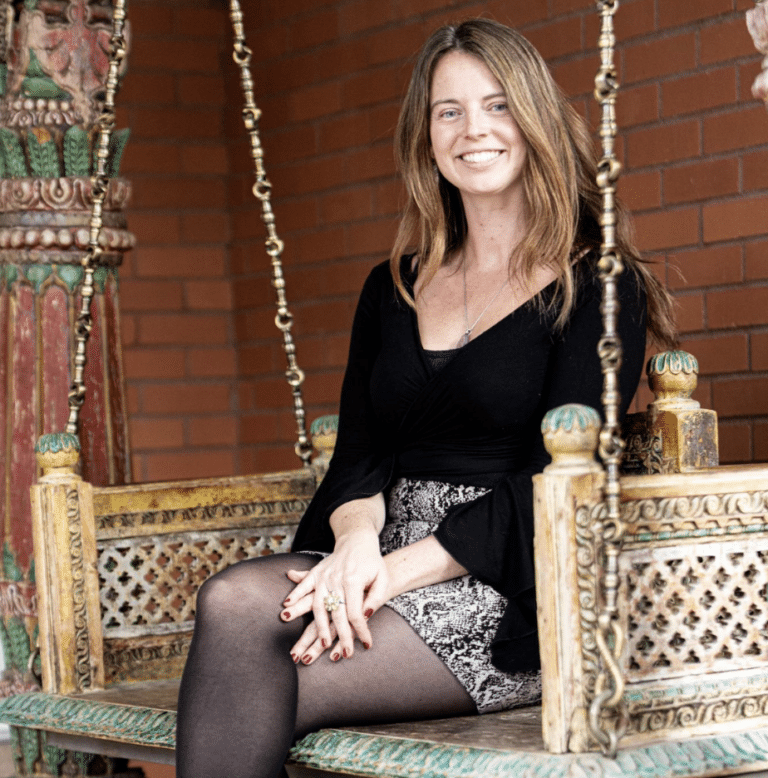 Kendall Higgins on the swing near the library